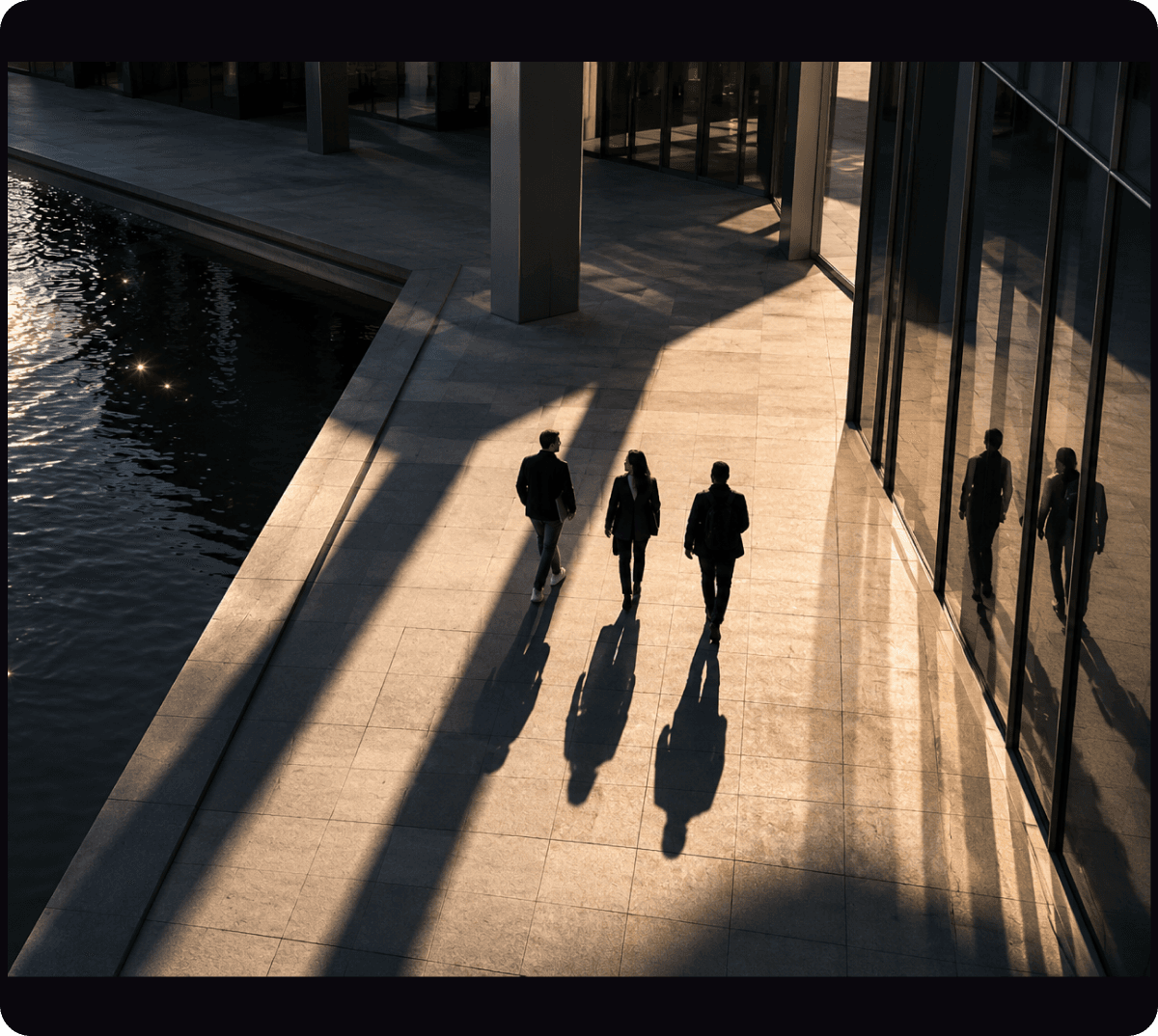 Colleagues walking together through a sunlit atrium.